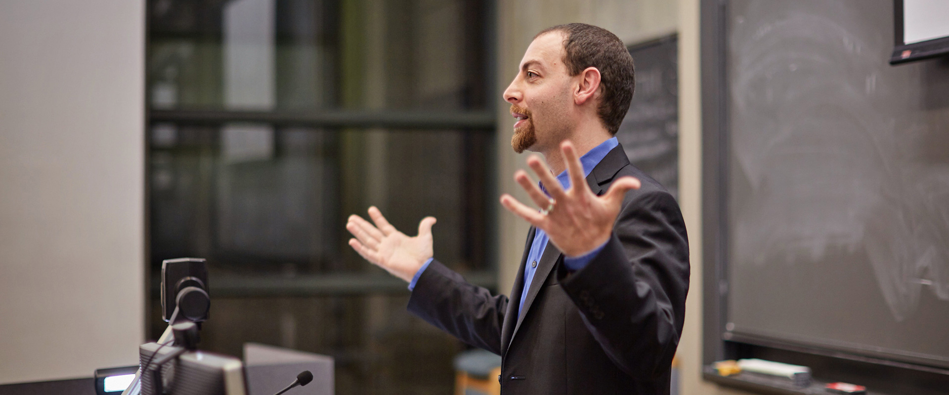 A photo of Dr. David Offenberg, associate professor of Finance at LMU, lecturing in a classroom